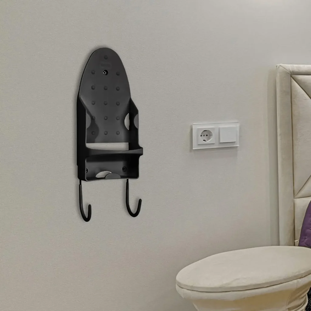 Wall-mounted ironing board holder with iron storage hook for space-saving laundry room organization.